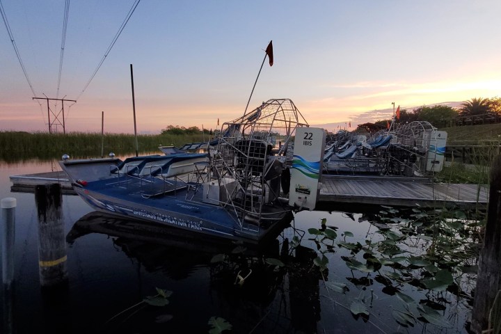 a boat is docked next to a body of water